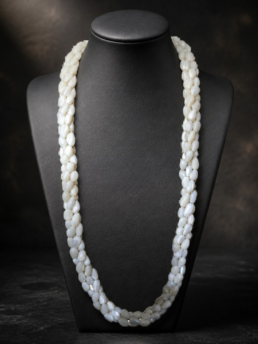 a triple-strand twisted necklace made from mother-of-pearl (MOP) shell beads